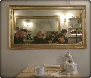 Reflection of people on table in restaurant