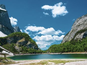 Scenic view of sea and mountains against sky