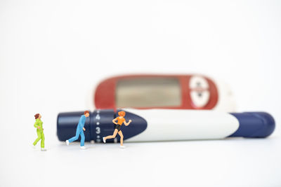 Close-up of toy on table against white background