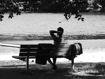 Young woman sitting on tree