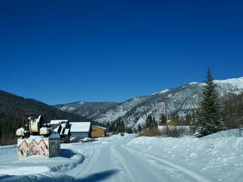 Scenic view of snowcapped mountains against clear blue sky