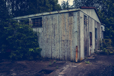 Old wooden house amidst trees