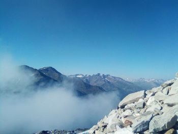 Scenic view of snowcapped mountains against clear blue sky