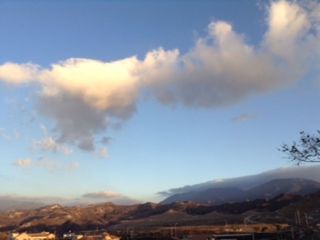 Scenic view of mountains against cloudy sky