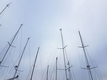 Low angle view of sailboat moored at harbor against clear sky