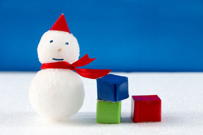 Close-up of christmas decorations against blue background