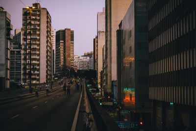 View of skyscrapers in city during sunset 