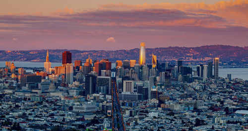 Modern buildings in city against sky during sunset, san francisco