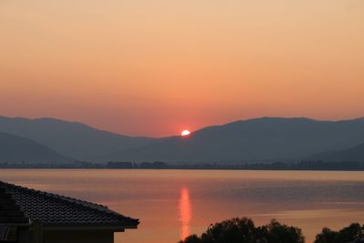 Scenic view of lake against romantic sky at sunset