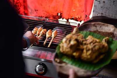 Close-up of meat cooking skewer meat on barbecue grill