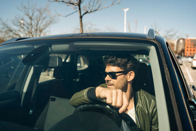 Portrait of man sitting in car