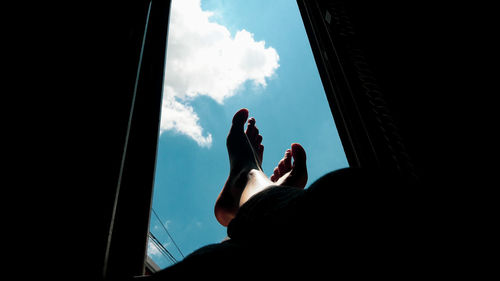 Low angle view of man standing against sky