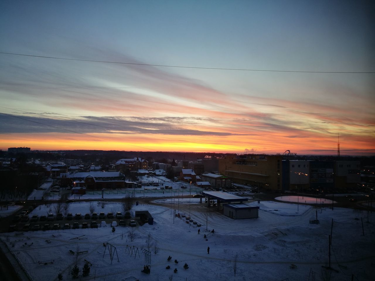 SNOW COVERED LANDSCAPE AGAINST SKY DURING SUNSET