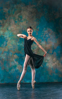 Full length portrait of young woman dancing