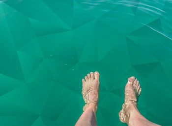 Low section of person in swimming pool