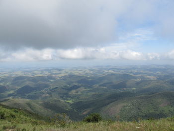 Scenic view of mountains against cloudy sky