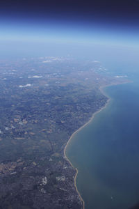 Aerial view of sea and cityscape against sky