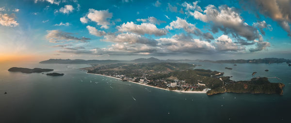 High angle view of townscape by sea against sky during sunset