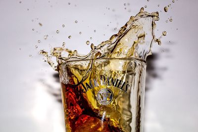 Close-up of ice splashing in glass