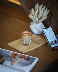 High angle view of coffee and laptop on table