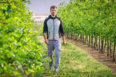 Portrait of young man standing in farm