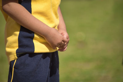 Midsection of boy standing on outdoors