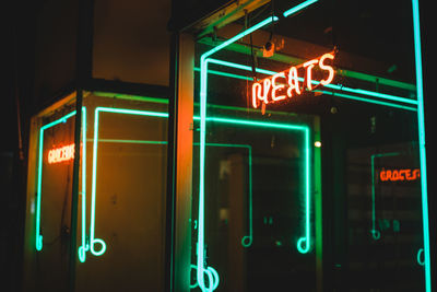 View of illuminated neon sign at night