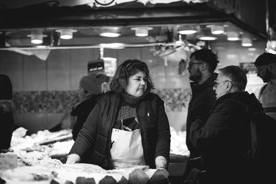 Group of people at illuminated shop