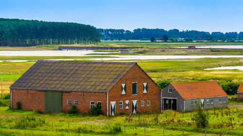 Houses on field against sky