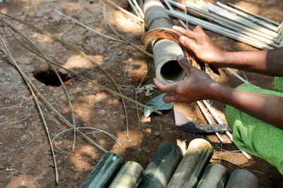 Low section of person working on metal