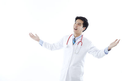 Young man standing against white background