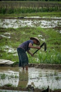 Side view of man working on field