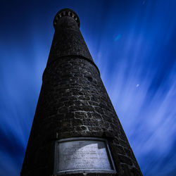 Low angle view of tower against blue sky