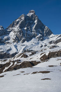 Scenic view of snowcapped mountains against clear sky