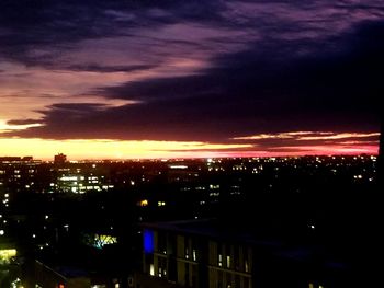 Illuminated cityscape against sky at night