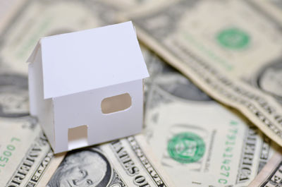 High angle view of model home with paper currencies on table