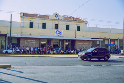 People on street against buildings in city