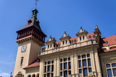 Low angle view of buildings against blue sky