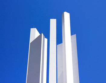 Low angle view of modern building against blue sky