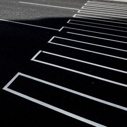 Detail shot of white lines on asphalt road