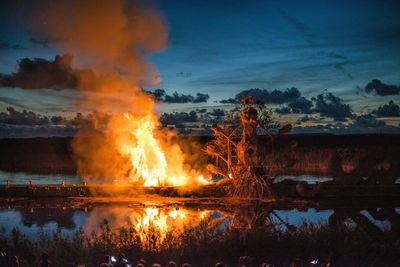 Close-up of illuminated fire against sky at night