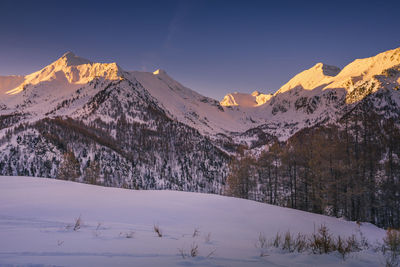 Scenic view of snow covered mountains against sky