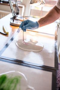 Cropped hand of scientist doing experiment in food laboratory