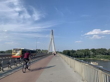Bicycle on bridge against sky