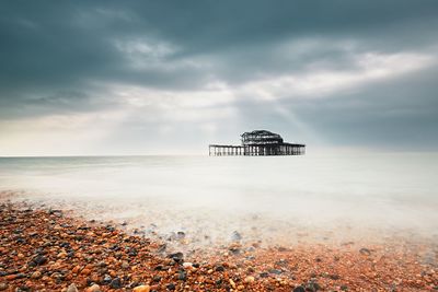 Scenic view of sea against storm clouds