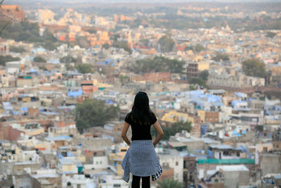 Rear view of woman looking at cityscape