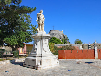 Statue against clear blue sky