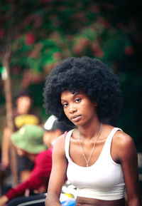 Portrait of young woman sitting outdoors