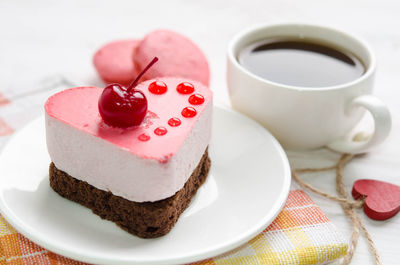 Close-up of cake with coffee on table