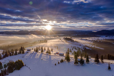 Scenic view of snowcapped landscape against sky during winter